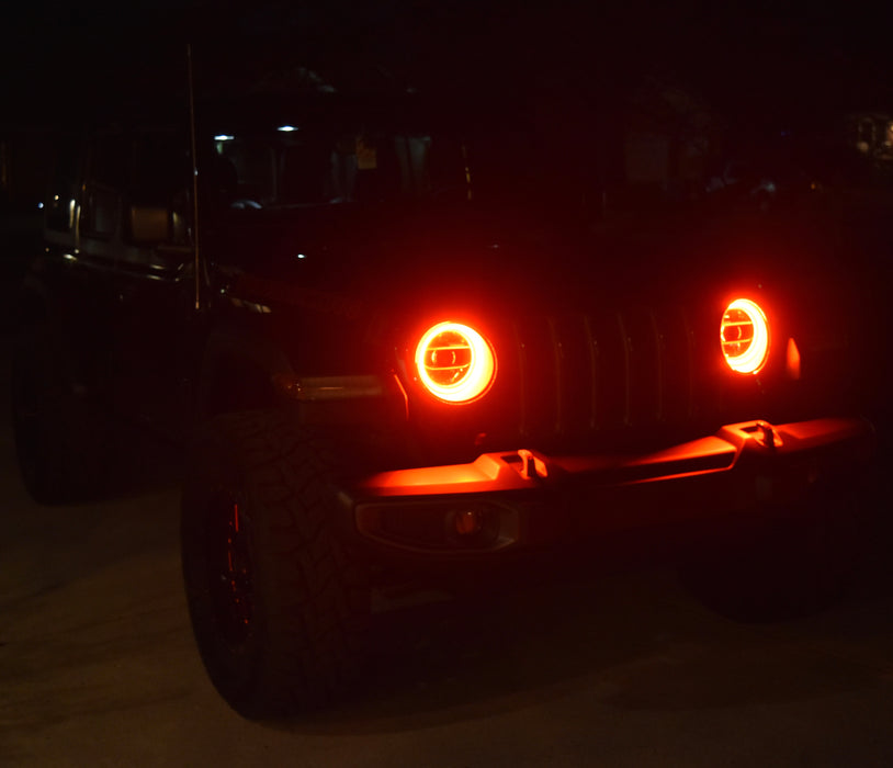 Jeep at night with red headlight halos on.