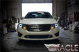 Front end of a Ford Fusion with white LED headlight halo rings installed.