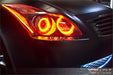 Close-up of red LED headlight halo rings installed on an Infiniti G37.