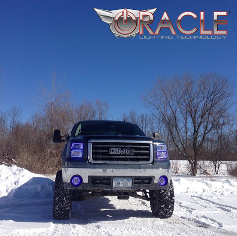 Front view of a GMC Sierra with blue LED fog light and headlight halo rings installed.