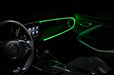 Car interior with green fiber optic lighting installed on the dashboard.