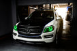 Three quarters view of a Mercedes GL Class with green headlight halos and DRLs.