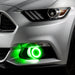 Close-up on the front bumper of a silver Ford Mustang equipped with green fog light halos.