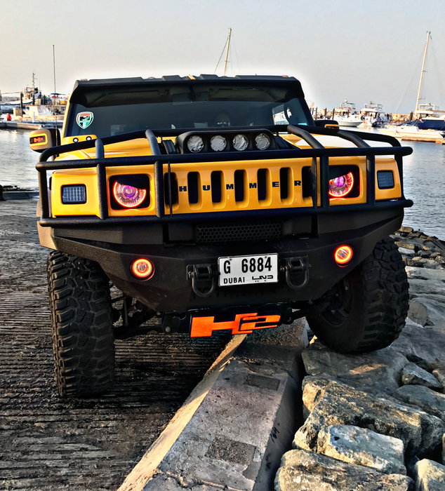 Front end of a Hummer H2 with amber LED headlight and fog light halo rings installed.