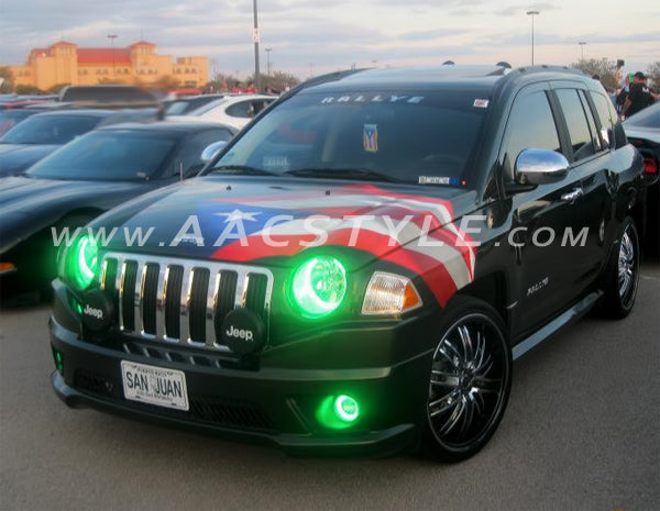 Three quarters view of a Jeep Patriot with green LED headlight and fog light halo rings installed.