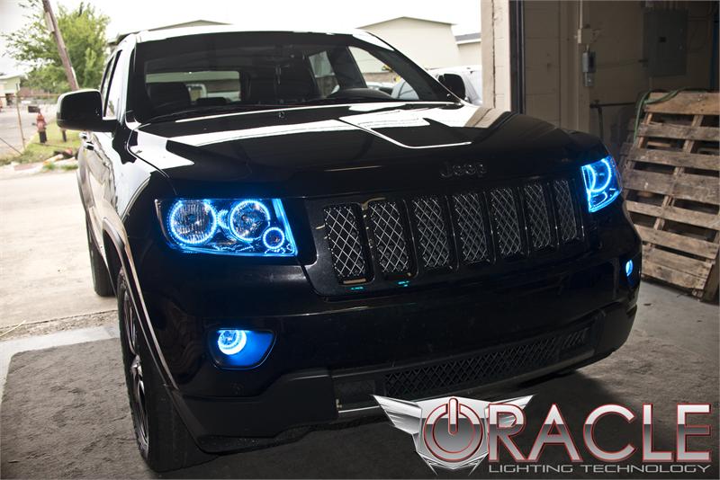 Front end of a Jeep Grand Cherokee with blue LED headlight halo rings.