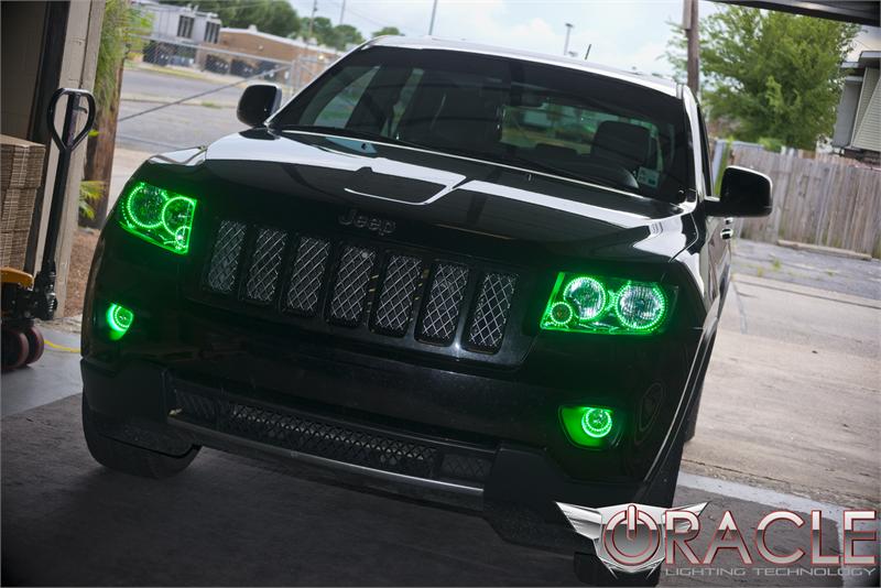 Front end of a Jeep Grand Cherokee with green LED headlight and fog light halos.