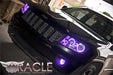 Front end of a Jeep Grand Cherokee with purple LED headlight and fog light halos.