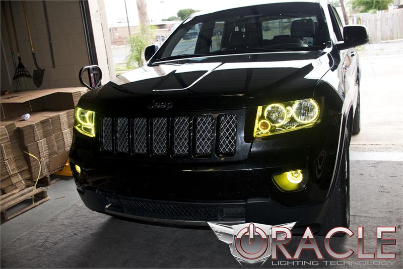 Front end of a Jeep Grand Cherokee with yellow LED headlight and fog light halos.