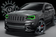 Three quarters view of a Jeep Cherokee with green headlight DRLs.