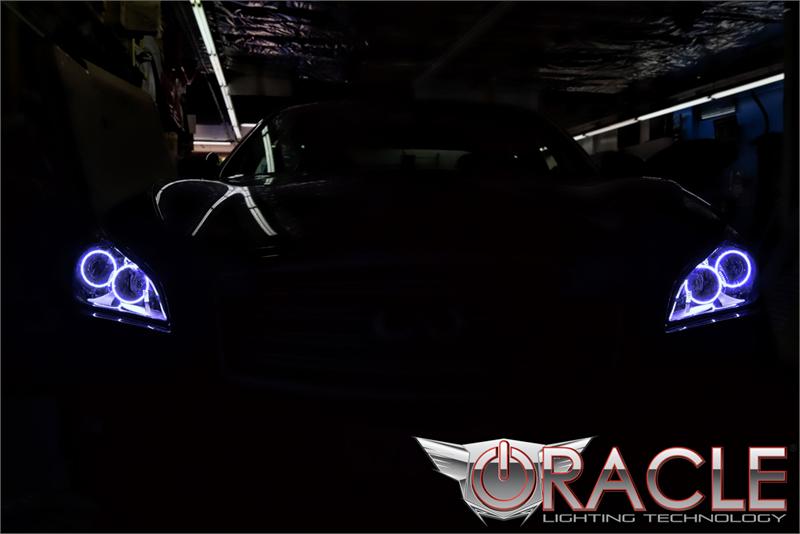 Front end of an Infiniti M37 with white LED headlight halo rings installed.