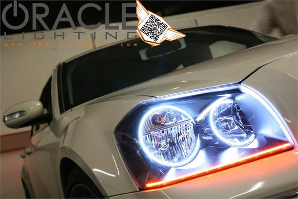 Close-up of white LED headlight halo rings installed on a Dodge Magnum.