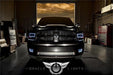 Front end of a dodge Ram with white LED headlight and fog light halo rings.