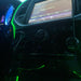 Close-up of green fiber optic lighting installed on the front console of a vehicle.