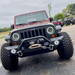 Front end of a Jeep Wrangler with 7" High Powered LED Headlights installed, and white halos on.
