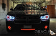 Front end of a black Dodge Charger with white LED headlight halo rings installed.