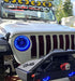 Front end of a Jeep with ColorSHIFT Oculus Headlights installed, with blue halos on.