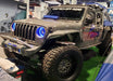 Three quarters view of a Jeep Gladiator JT in a showroom, with ColorSHIFT Oculus Headlights installed.
