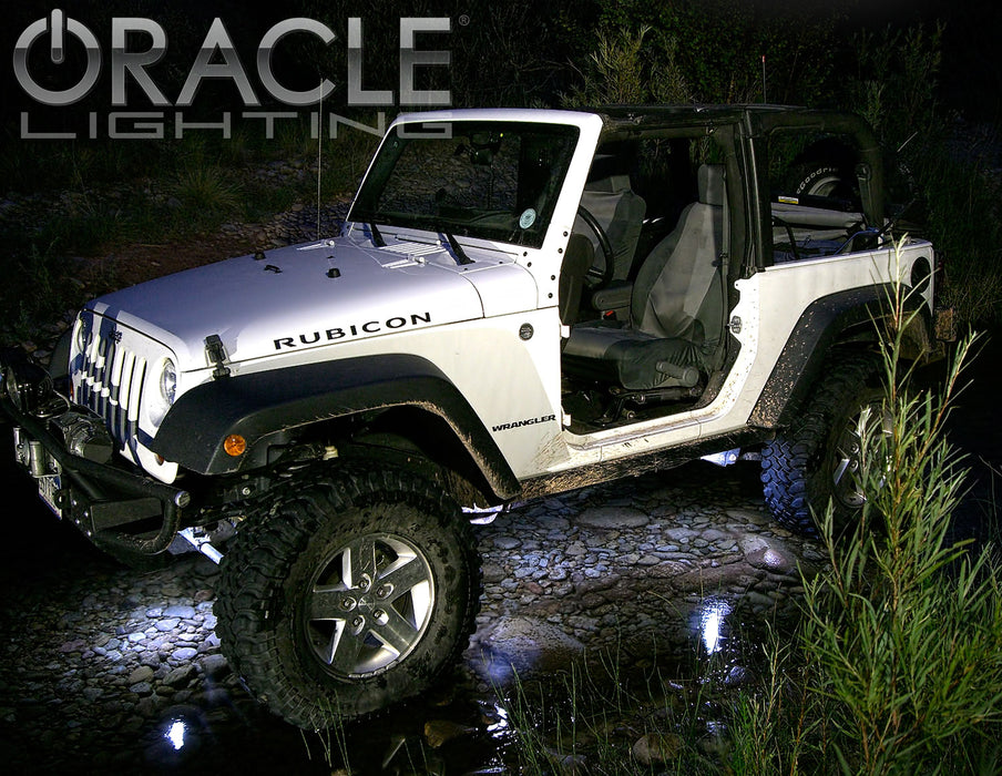 Jeep outdoors with white rock lights shining underneath