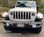 Front end of a white Jeep Gladiator with Oculus Headlights installed.