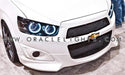 Front end of a Chevrolet Sonic with white LED headlight halo rings installed.