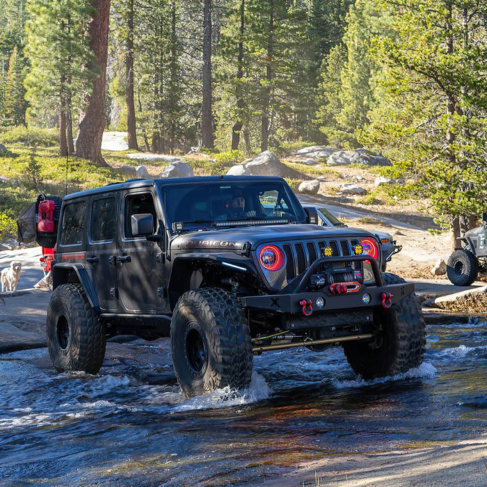Jeep outdoors in the water with bright red halo headlights