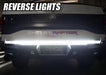 Rear view of ford raptor with LED truck tailgate light bar reverse lights on