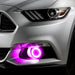Close-up on the front bumper of a silver Ford Mustang equipped with pink fog light halos.