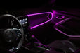 Car interior with pink fiber optic lighting installed on the dashboard.