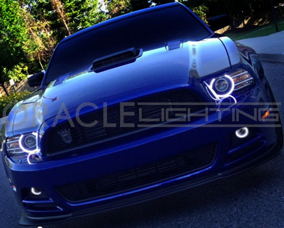 Front end of a Ford Mustang with white LED headlight and fog light halo rings installed.
