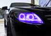 Close-up on the headlight of a Mercedes Benz CL 500 with purple LED halo rings.