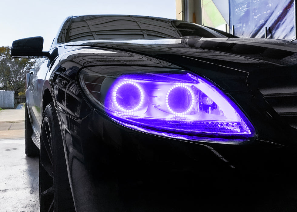 Close-up on the headlight of a Mercedes Benz CL 500 with purple LED halo rings.