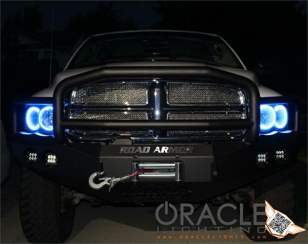 Front end of a Dodge Ram with white LED headlight halo rings installed.