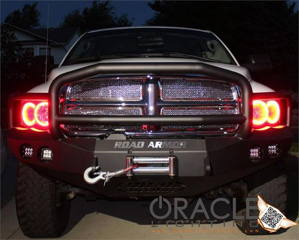 Front end of a Dodge Ram with red LED headlight halo rings installed.