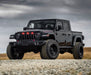 Lifestyle image of a Jeep Gladiator JT with red Pre-Runner Style LED Grill Light Kit installed.