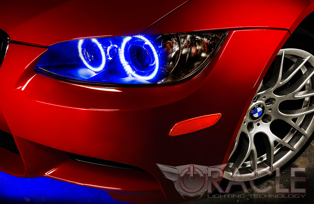Close-up of a BMW M3 headlight with blue halo rings installed.