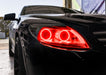 Close-up on the headlight of a Mercedes Benz CL 500 with red LED halo rings.