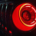 Close-up on a ColorSHIFT Oculus Headlight installed on a Jeep, with red halo rings.