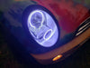 Close-up of white LED headlight halo rings installed on a Mini Cooper.