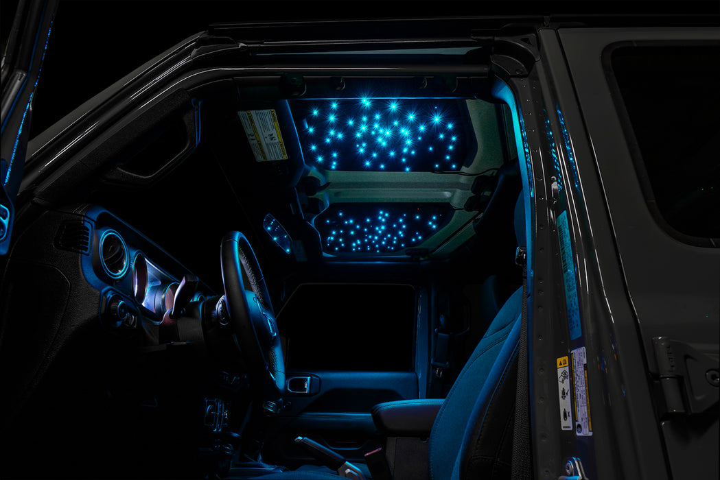 Jeep interior with StarLINER Fiber Optic Hardtop Headliner installed on the roof panels, set to cyan LEDs.