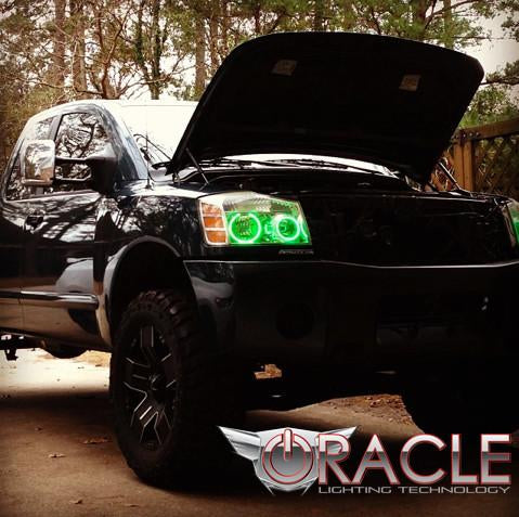 Three quarters view of a Nissan Titan with green LED headlight halo rings installed.