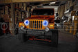 Front view of a Jeep with white LED headlight halo rings installed.