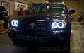 Front end of a Toyota 4Runner with white LED headlight halo rings installed.