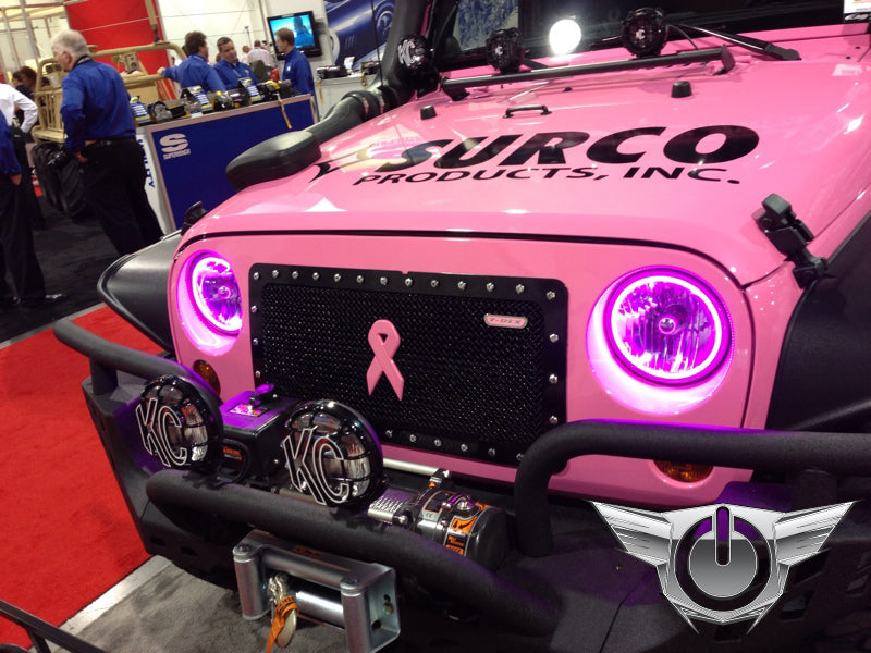Front end of a pink Jeep with pink LED headlight halos installed.