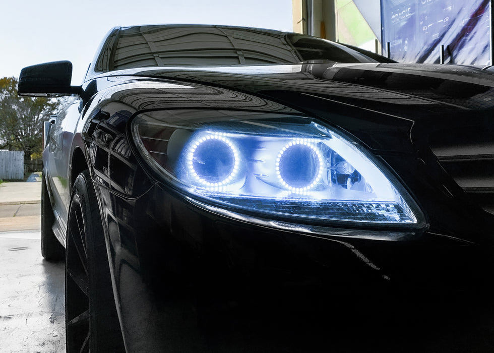 Close-up on the headlight of a Mercedes Benz CL 500 with white LED halo rings.