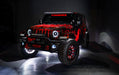 Three quarters view of a red Jeep Wrangler JL, with ColorSHIFT Oculus Headlights, and white halo rings.