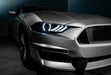 Close-up on a Ford Mustang headlight with white headlight halos and DRLs.